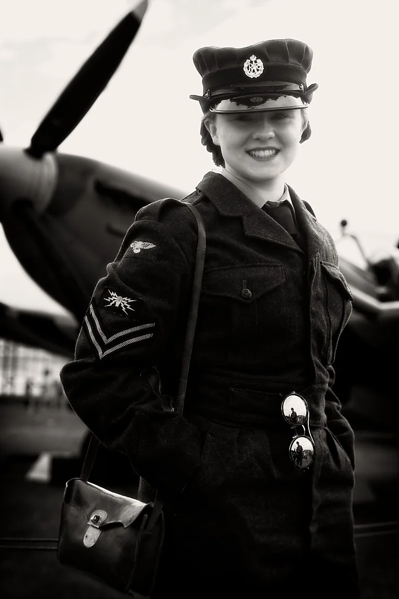Black-and-white portrait in a dark cap