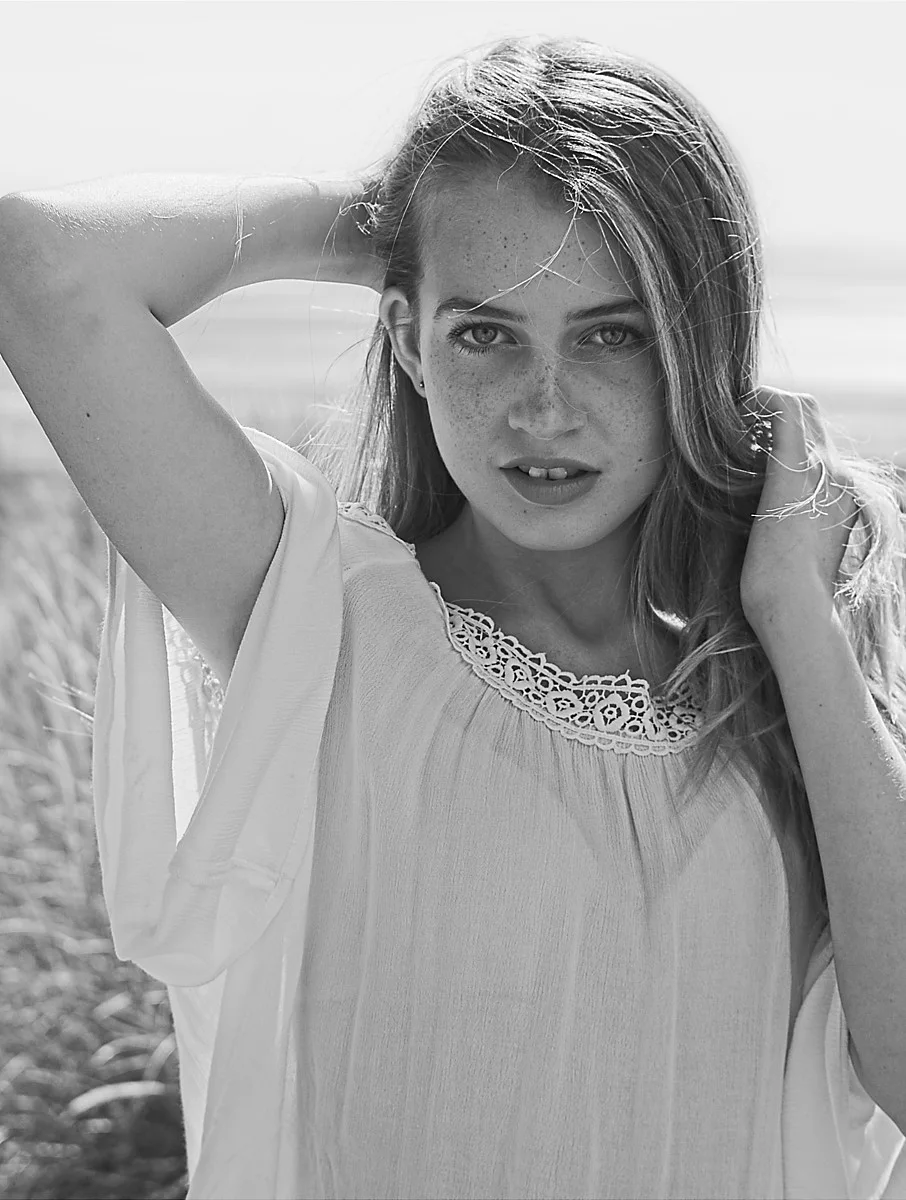 Black-and-white portrait with hand in hair