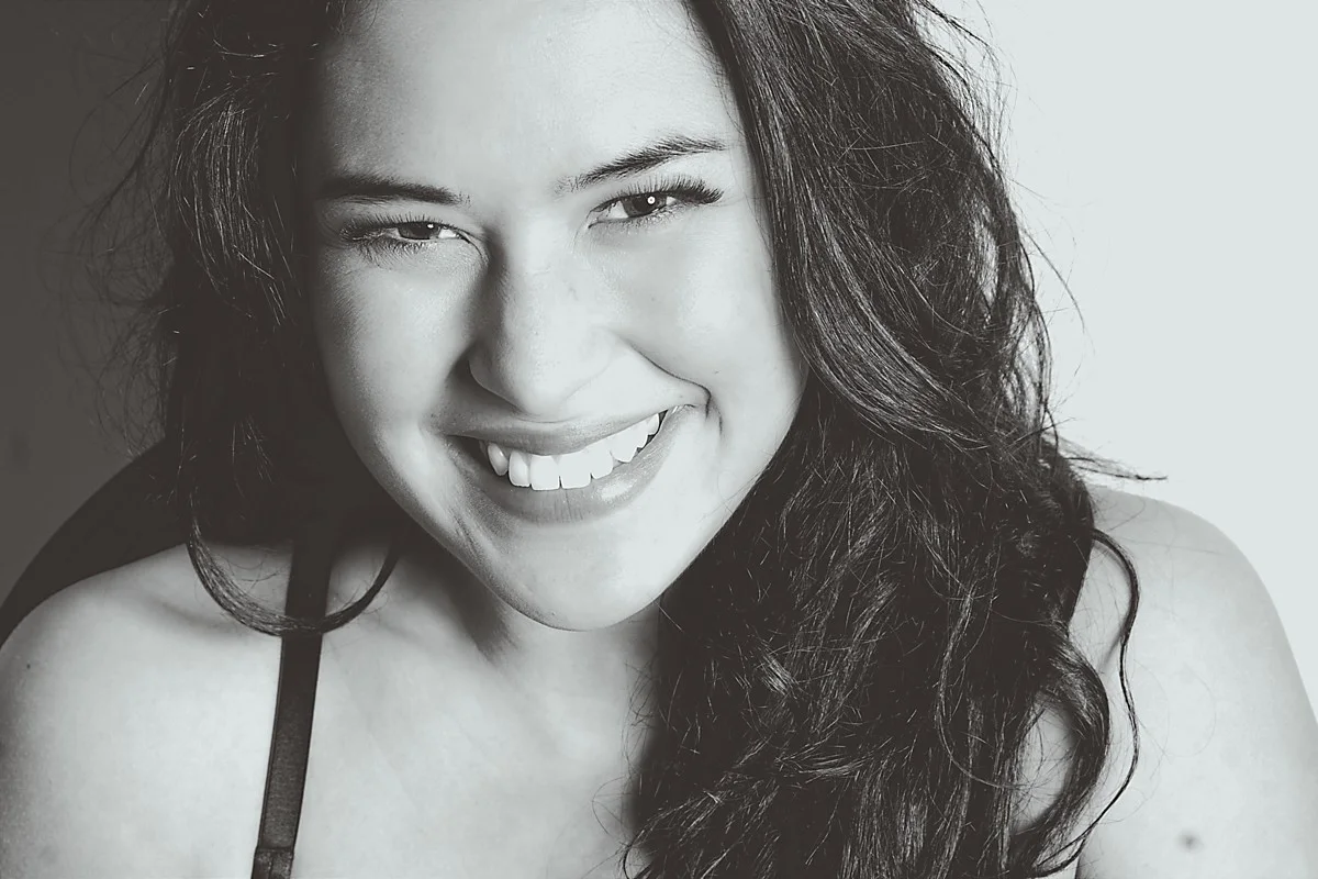 Smiling woman in a black-and-white close-up portrait