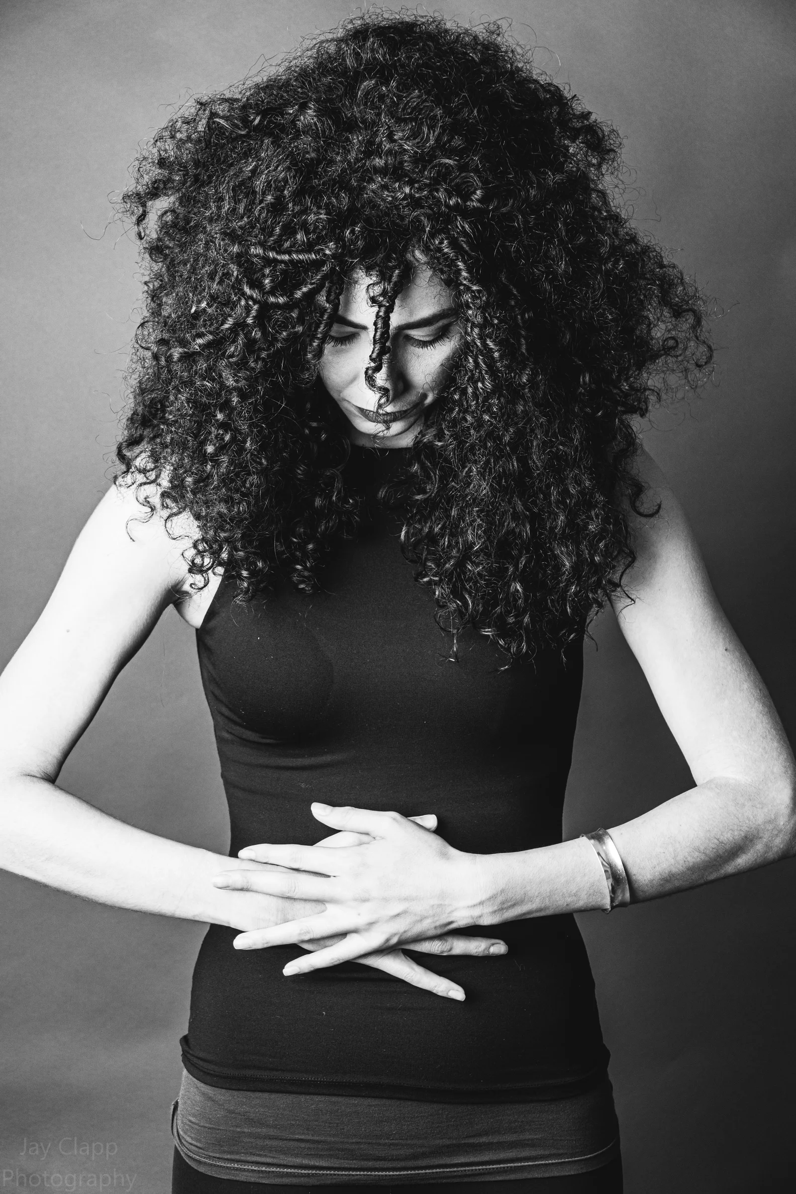 Curly haired black and white studio portrait