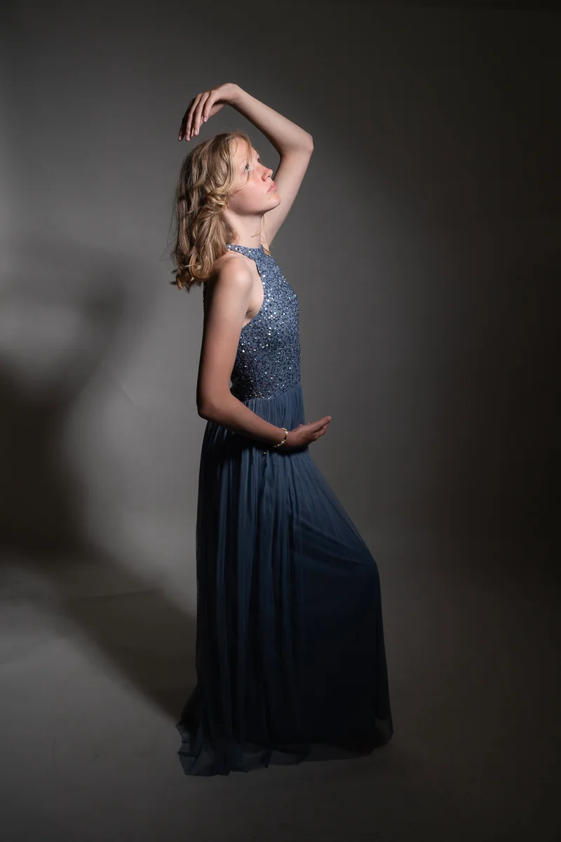 Woman in a dramatic blue studio portrait